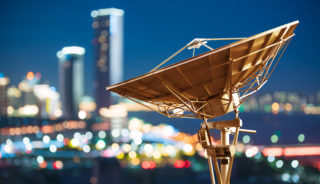 In the city night background large satellite antenna In the city night background large satellite antenna