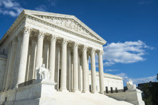 Supreme Court of the United States building front entrance with a scenic view of columns and steps under bright summer sun in Washington DC, USA Supreme Court of the United States building front entrance with a scenic view of columns and steps under bright summer sun in Washington DC, USA