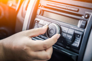 woman turning button of radio woman turning button of radio